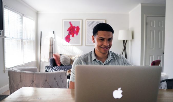 Photo of a man using a laptop
