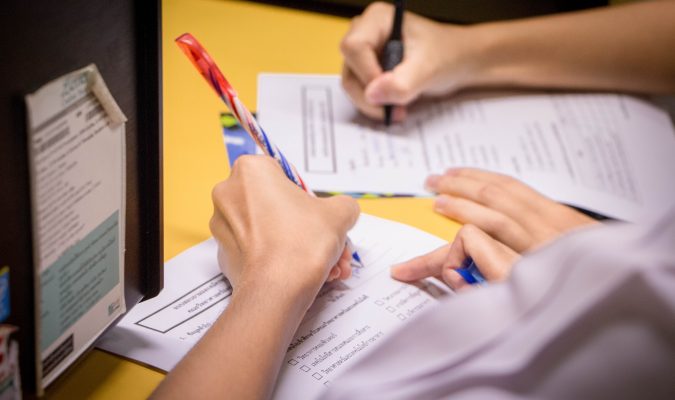 Photo of people filling documents
