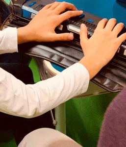 Photo of a child using a display braille