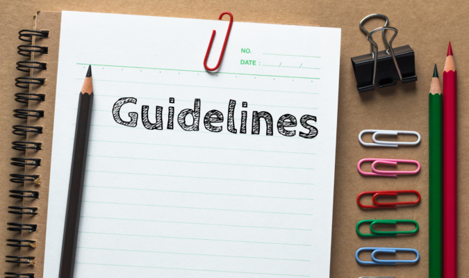 Photo of a desk with a blank paper with "Guidelines"